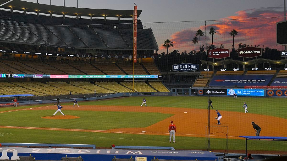 The Los Angeles Dodgers play the Los Angeles Angels at sunset during the fifth inning of a preseason baseball game, Tuesday, July 21, 2020, in Los Angeles.