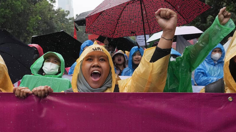 Female activists shout slogans during a rally celebrating International Women's Day in...