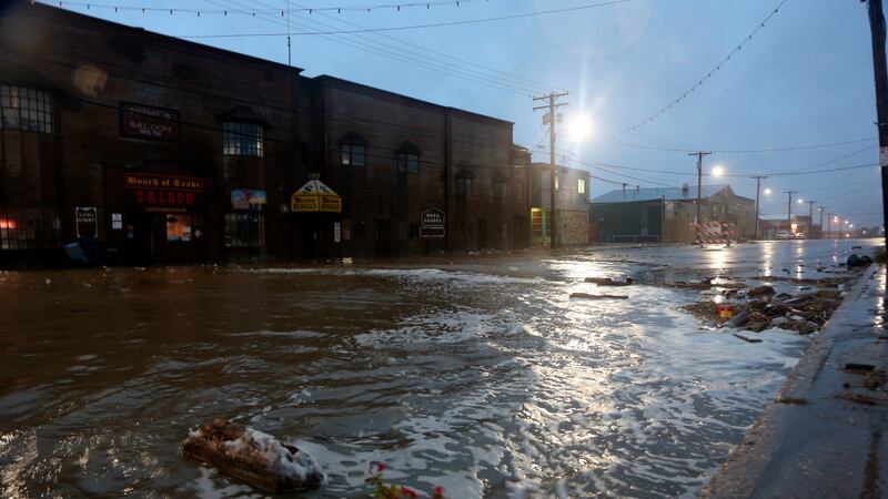 Water rushes down Front Street, just a half block from the Bering Sea, in Nome, Alaska, on...