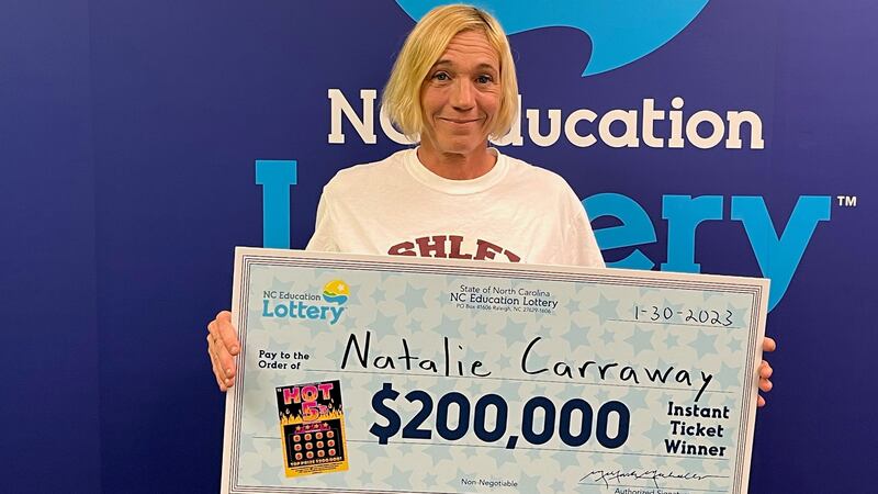 Carraway went to lottery headquarters Monday to claim her prize of $142,501 after required...