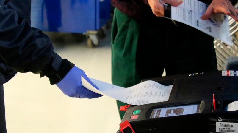 In this Saturday, March 14, 2020 photo, voters cast their ballots during early voting in...