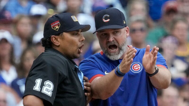 Chicago Cubs manager David Ross argues with home plate umpire Erich Bacchus during the sixth...